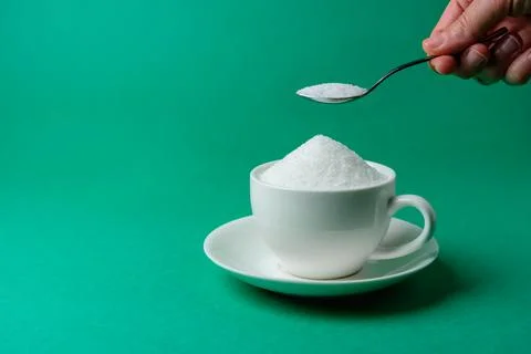 Cup full of sugar, too much, overeating Stock Photos