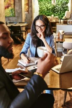 A cup of gourmet coffee shared with a friend is happiness tasted and time well Stock Photos