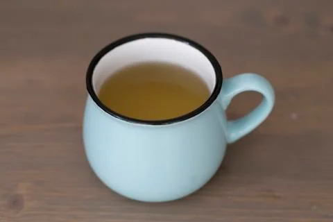 A cup of green tea on a coffee table Stock Photos