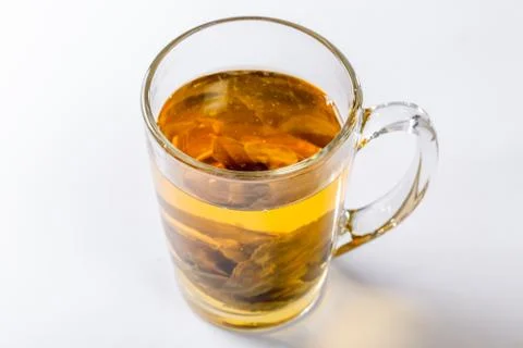 A Cup of green tea with large leaf tea on a white background. Diet and health Stock Photos