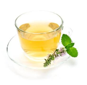 Cup of green tea with mint leaves and flower Stock Photos