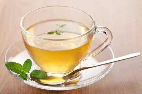 Cup of green tea with mint Stock Photos