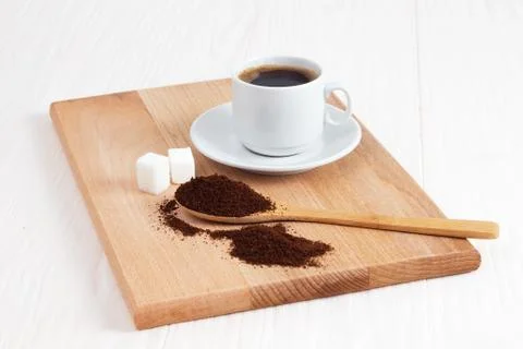 Cup of ground coffee in a spoon on the table Stock Photos