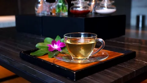 Cup of healing ginger tea after massage at resort and spa salon Stock Footage 208703102