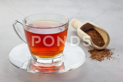 Cup of healthy herbal rooibos red tea in glass cup Stock Photos