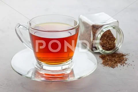 Cup of healthy herbal rooibos red tea in glass cup Stock Photos