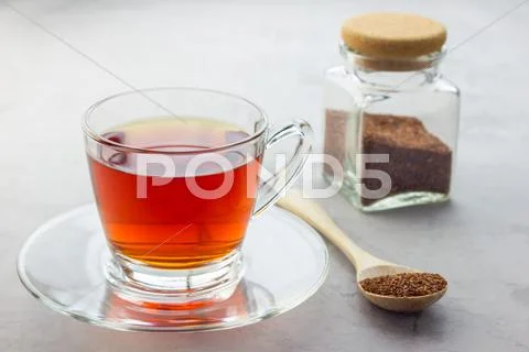 Cup of healthy herbal rooibos red tea in glass cup Stock Photos