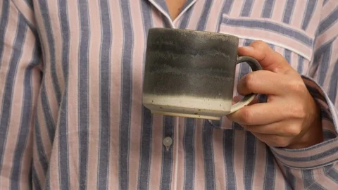 A cup held by two hands Stock Footage 104929976