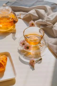 Cup of herbal chamomile tea on a table. Chamomile tea in a transparent cup an Stock Photos
