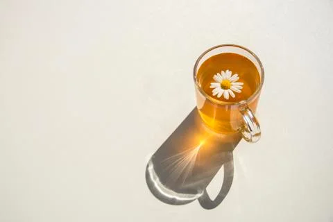 Cup of herbal chamomile tea on white table Stock Photos