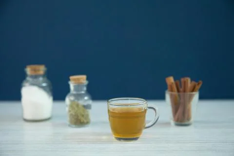 A cup of herbal tea and cinnamon sticks Stock Photos