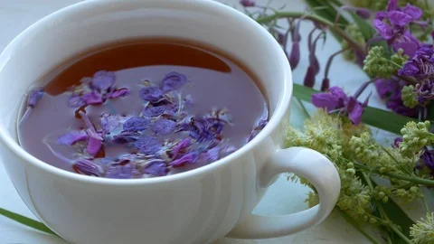 Cup of herbal tea . Tea leaves at the bottom of the cup. Stock Footage 111237275