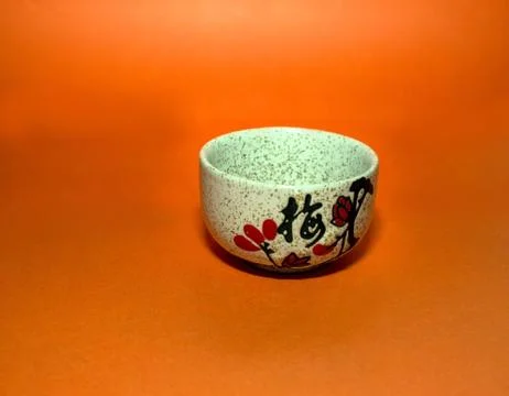Cup with a hieroglyph on an orange background Stock Photos