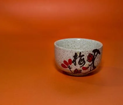 Cup with a hieroglyph on an orange background Stock Photos