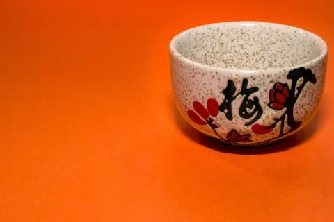 Cup with a hieroglyph on an orange background Stock Photos
