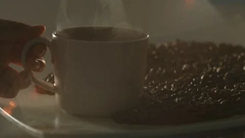Cup of hot American coffee and coffee beans in the background Stock Footage 135697853