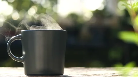 Cup for a hot beverage. Coffee brewing on wooden table in the early morning Stock Footage 242419859
