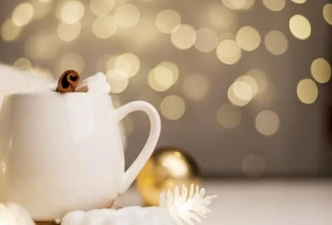 Cup of hot cocoa with marshmallows, background with Christmas lights of bokeh Stock Photos
