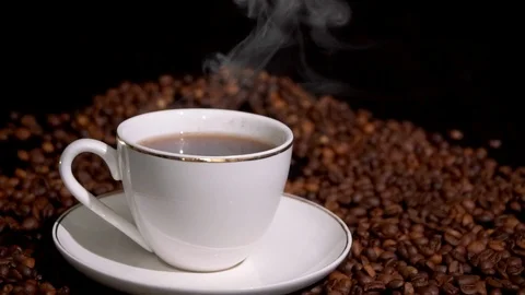 Cup with hot coffee and steam on a dark background Stock Footage 105755652