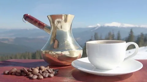 A cup of hot coffee on a background of mountains. Coffee. Video. Stock Footage 69122417
