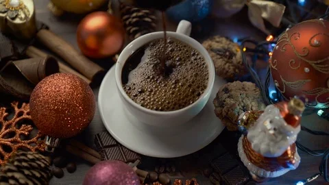Cup of hot coffee with cinnamon sticks on wooden table among Christmas Stock Footage 82533102