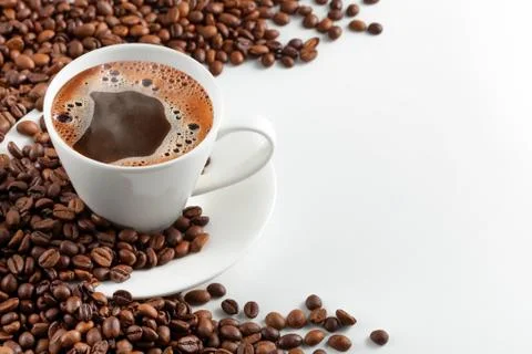A cup of hot coffee with coffee beans on a white background Stock Photos