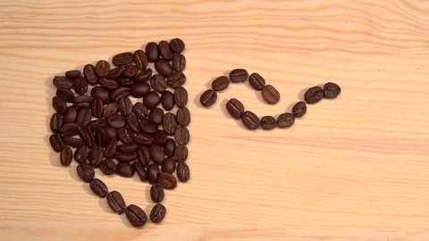 Cup of hot coffee is drawn from coffee beans. Cup of hot beverage with Steam. Video stock 70959168