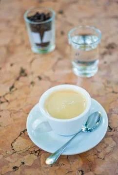 Cup of hot coffee on a marble table . Shallow depth of field Фото
