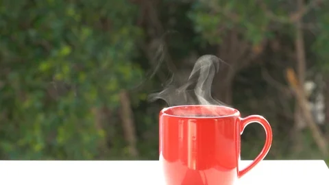 Cup of hot coffee or tea at window side abstract blur background Stock Footage 85569856