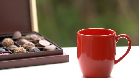 Cup of Hot Coffee or Tea. Cup of hot beverage with Steam. chocolate package Stockbeeldmateriaal 85976277