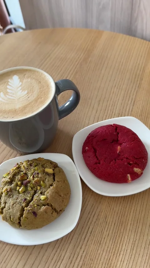 Cup of hot coffee with a pattern in a gray cup cappuccino latte and two cookies Stock Footage 303487106
