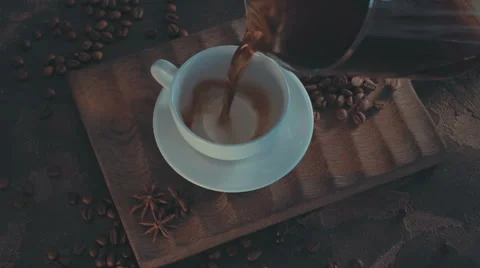 Cup of hot coffee with roasted beans on rustic wooden background Stock Footage 65792332