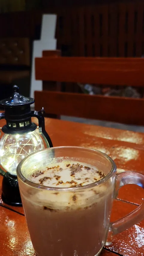 A cup of Hot Coffee with a small black lamp Stock Footage 286311163