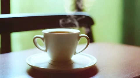 A cup of hot coffee standing on a table Stock-Footage 240473714