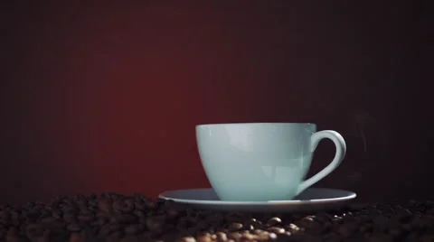 Cup of hot coffee with steam on a dark background Stock Footage 55291825