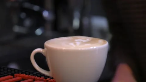Cup of hot coffee on table in cafe with people Stock Footage 122627006