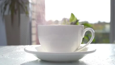 Cup of hot coffee on the table. The coffee is poured into the cup. Stock Footage 161171040