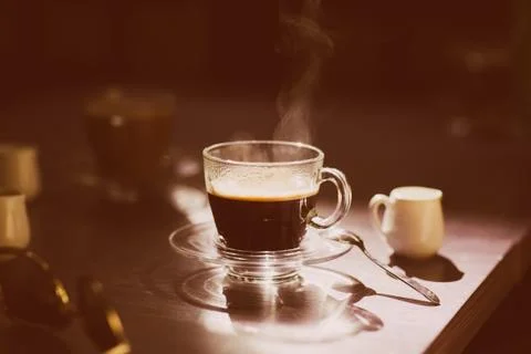 Cup of hot coffee on the table Stock Photos