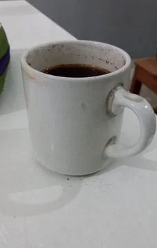 A cup of hot coffee on a white table Stock Illustration