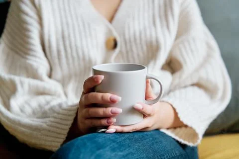 Cup of hot drink on sofa Stock Photos
