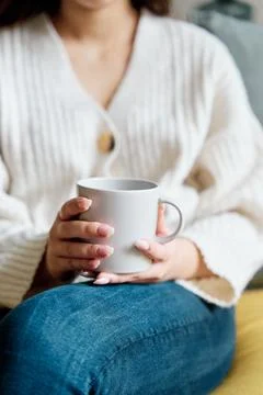 Cup of hot drink on sofa Foto stock