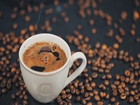 Cup of hot drink with steam over black background. Slow motion Stock Footage 73669751