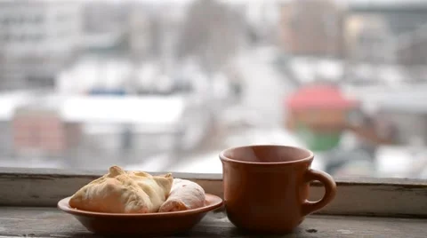 Cup with hot drink steaming and buns on saucer Stock Footage 46338205
