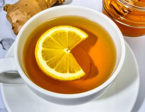 Cup of Hot Ginger Tea with Lemon Slice and Honey for Premium Herbal Drink O.. Stock Photos