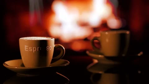 A cup of hot steaming coffee next to the fireplace. Stock Footage 132365507