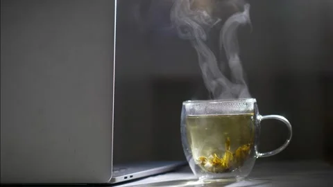 Cup of hot steaming tea on a table with steam coming from hot herbal tea Stock Footage 150359090