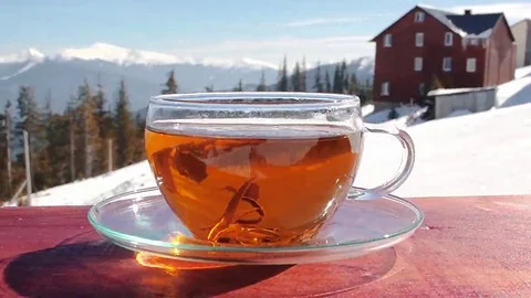 A cup of hot tea on a background of mountains. Tea. Video. Stock Footage 69122579