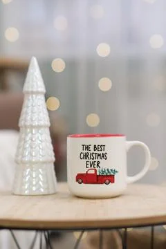 Cup of hot tea on caffee table in living room. Christmas home interior. Ceramic Stock Photos