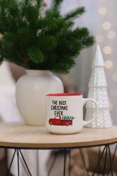 Cup of hot tea on caffee table in living room. Christmas home interior. Ceramic Stock Photos