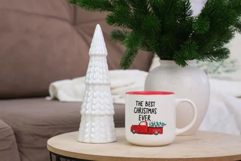 Cup of hot tea on caffee table in living room. Christmas home interior. Ceramic Stock-Fotos